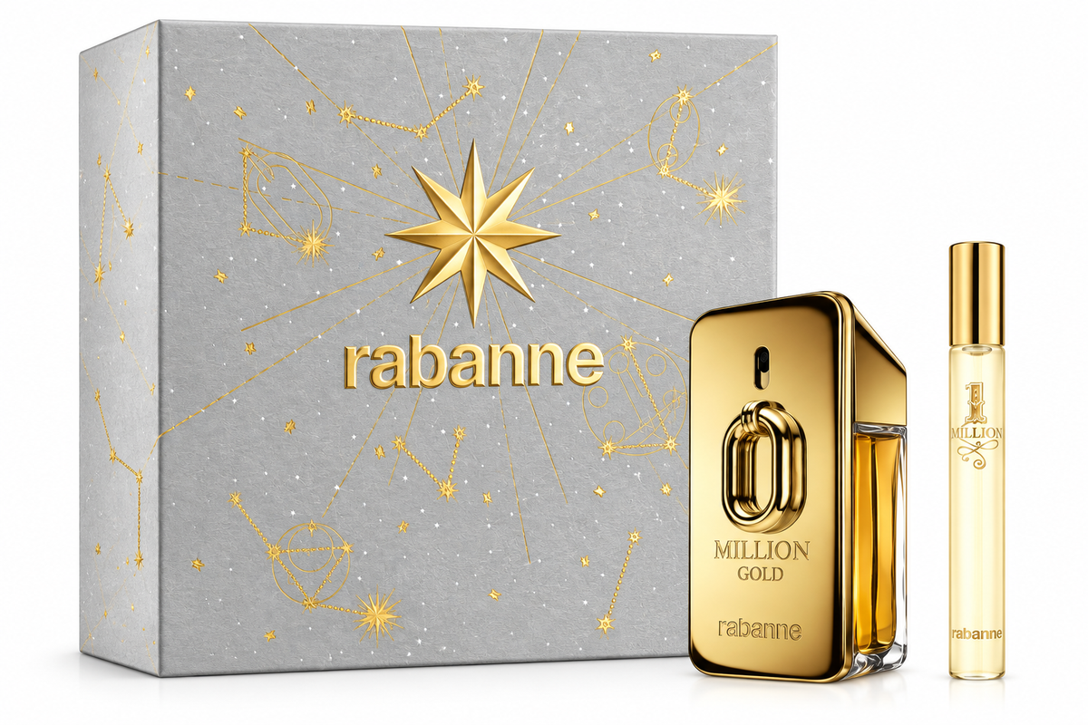Rabanne Million Gold gift set featuring the metallic gold Million Gold fragrance bottle and matching travel spray, presented beside an elegant silver gift box decorated with intricate gold celestial motifs, constellations and a prominent star design. Luxurious gold detailing, recognizable Rabanne branding and premium gift-ready presentation on a clean white background.