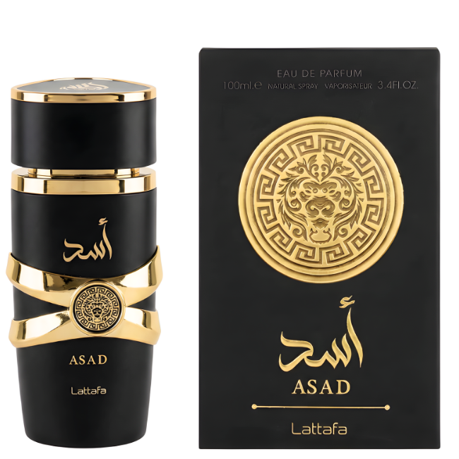 A 100ml matte black cylindrical bottle of Lattafa Asad Eau De Parfum with gold ribbon hardware, standing next to its large matte black gift box featuring a massive, detailed gold lion head emblem in a decorative circular frame.