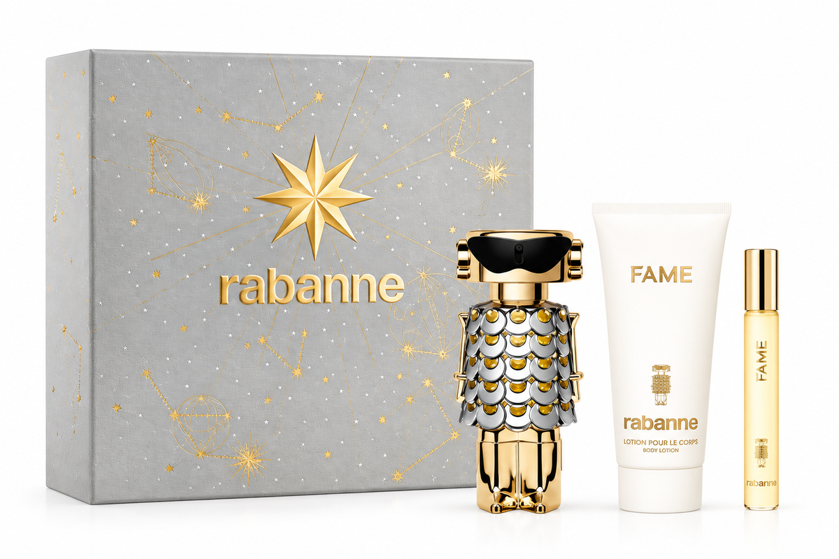 Rabanne Fame gift set featuring the iconic robot-shaped Fame perfume bottle with gold and silver detailing, matching Fame body lotion and travel-size fragrance, presented beside an elegant silver gift box decorated with gold celestial motifs and Rabanne branding.