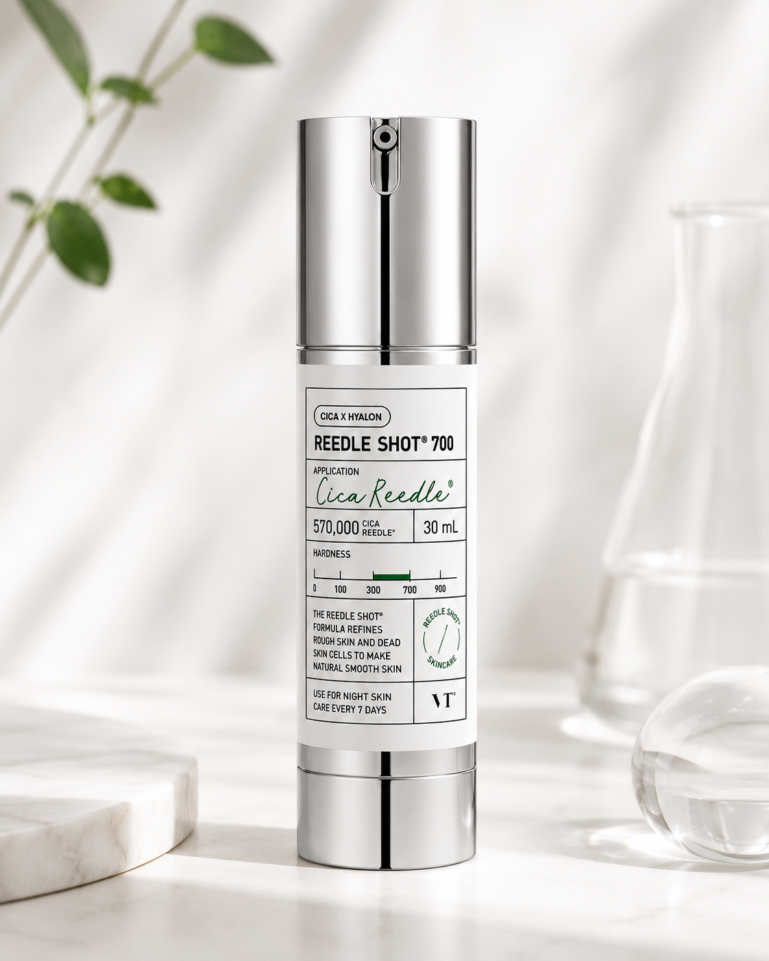 VT Cosmetics Reedle Shot 700 30ml elegantly displayed in a minimalist spa-inspired skincare setting with soft natural light, clean glass accents, fresh botanical elements and a luxurious white aesthetic, highlighting its advanced Cica Reedle™ technology designed for intensive skin resurfacing, texture refinement, enhanced skincare absorption and a visibly smoother, healthier-looking complexion.