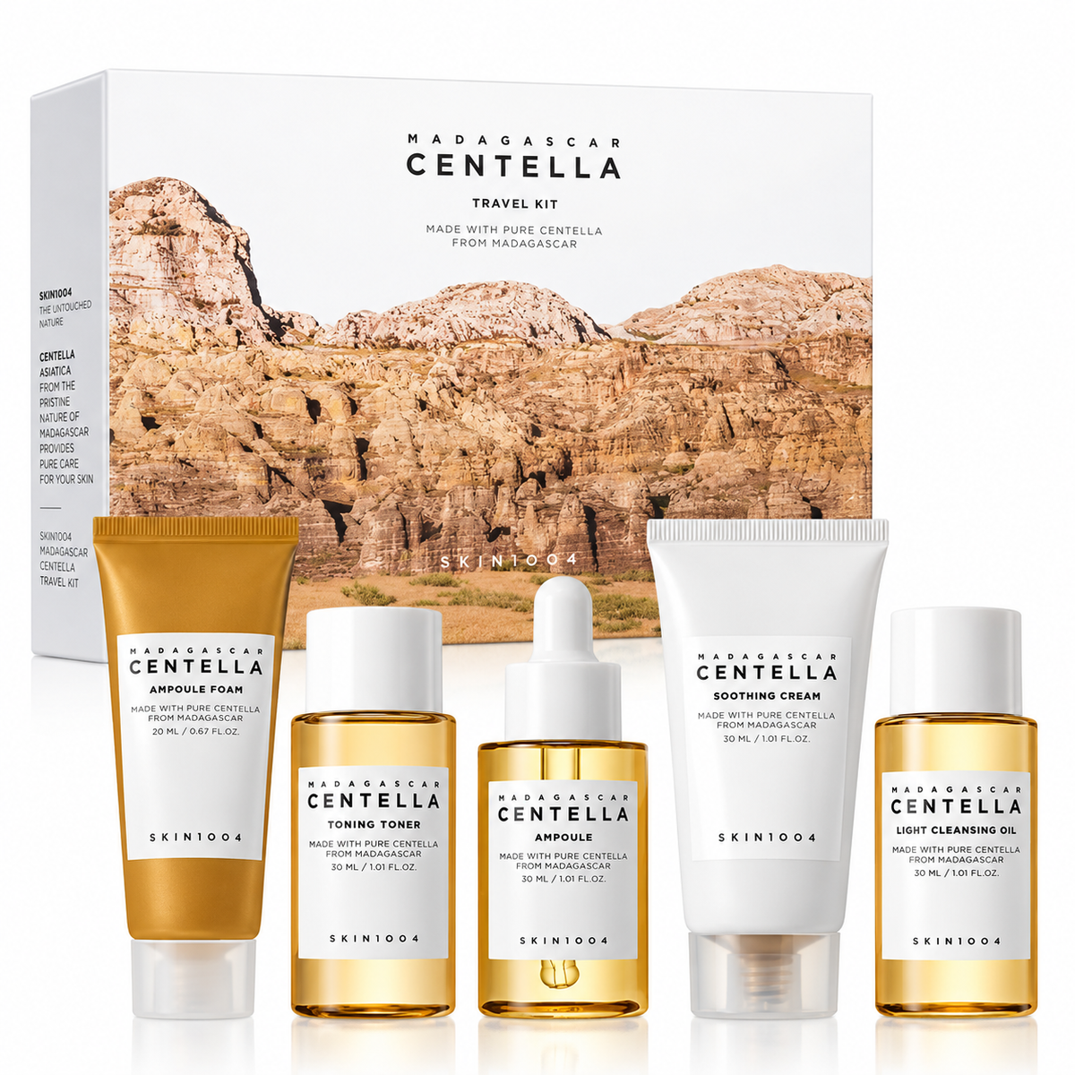 SKIN1004 Madagascar Centella Travel Kit featuring five travel-size skincare essentials: Light Cleansing Oil, Ampoule Foam, Toning Toner, Centella Ampoule and Soothing Cream, all formulated with pure Centella from Madagascar and presented with the matching gift box.
